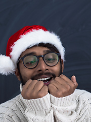 Image showing Indian man wearing traditional Santa  hat  and white sweater