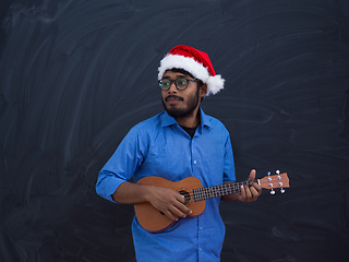 Image showing Santa playing Latin America traditional small guitar