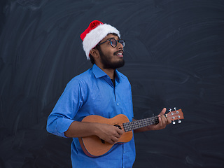 Image showing Santa playing Latin America traditional small guitar