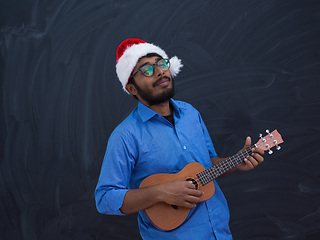 Image showing Santa playing Latin America traditional small guitar