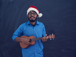 Image showing Santa playing Latin America traditional small guitar