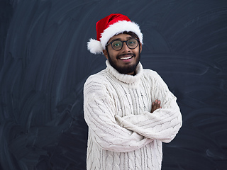 Image showing Indian man wearing traditional Santa  hat  and white sweater