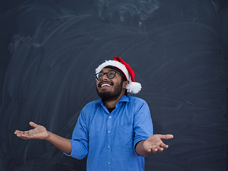 Image showing Indian man wearing traditional Santa Claus hat