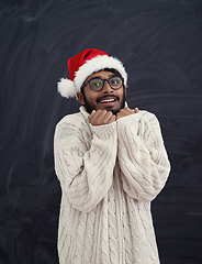 Image showing Indian man wearing traditional Santa  hat  and white sweater