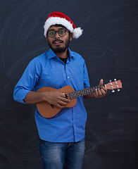 Image showing Santa playing Latin America traditional small guitar