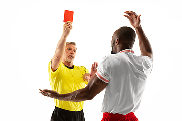 Image showing Football referee showing a red card to a displeased player isolated on white background