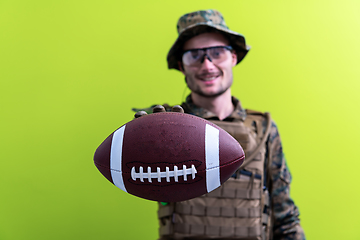 Image showing solder holding american football ball