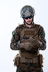 Image showing closeup of soldier hands putting protective battle gloves