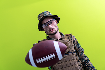 Image showing solder holding american football ball