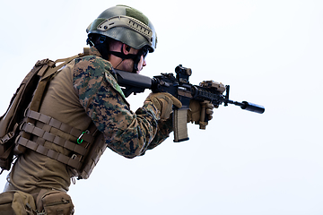 Image showing soldier in action aiming laseer sight optics