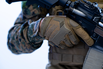 Image showing soldier preparing gear for action