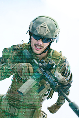 Image showing soldier in action aiming laseer sight optics