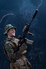Image showing soldier firing into the air in front of black chalkboard