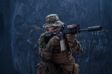 Image showing soldier in action aiming laseer sight optics