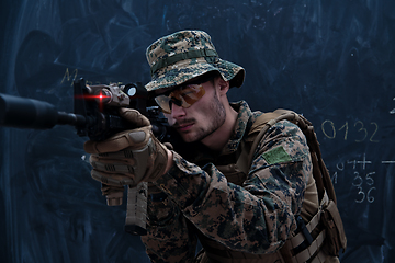 Image showing soldier in action aiming laseer sight optics