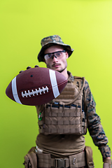 Image showing solder holding american football ball