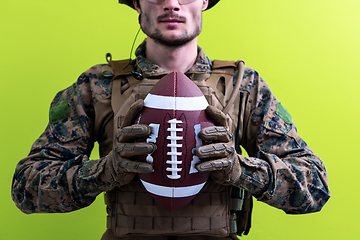 Image showing solder holding american football ball