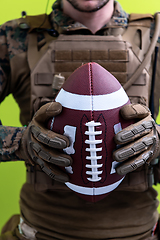 Image showing solder holding american football ball