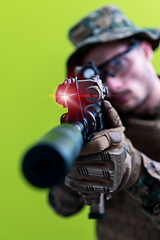 Image showing soldier in action aiming laseer sight optics green background