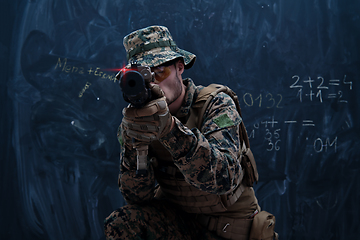 Image showing soldier in action aiming laseer sight optics