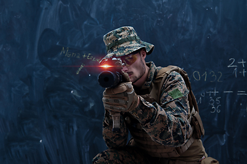 Image showing soldier in action aiming laseer sight optics