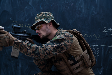 Image showing soldier in action aiming laseer sight optics