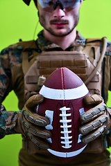 Image showing solder holding american football ball