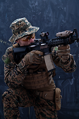 Image showing soldier in action aiming laseer sight optics