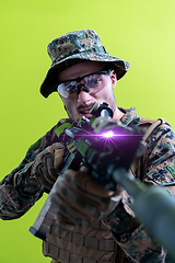 Image showing soldier in action aiming laseer sight optics green background