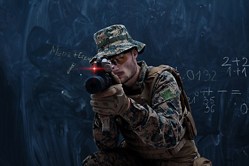 Image showing soldier in action aiming laseer sight optics