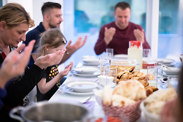 Image showing Eid Mubarak  Islamic family praying before halal Iftar dinner