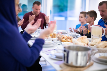 Image showing Eid Mubarak  Islamic family praying before halal Iftar dinner