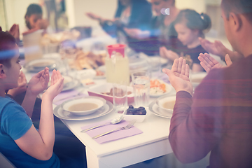 Image showing Eid Mubarak  Islamic family praying before halal Iftar dinner