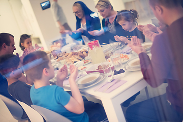 Image showing Eid Mubarak  Islamic family praying before halal Iftar dinner