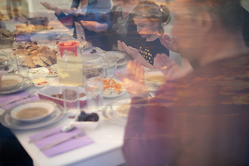 Image showing Eid Mubarak  Islamic family praying before halal Iftar dinner