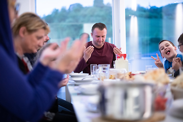 Image showing Eid Mubarak  Islamic family praying before halal Iftar dinner