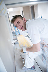 Image showing construction worker plastering on gypsum walls