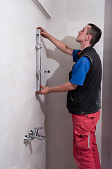 Image showing professional plumber working in a bathroom