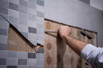 Image showing worker remove demolish old tiles in a bathroom