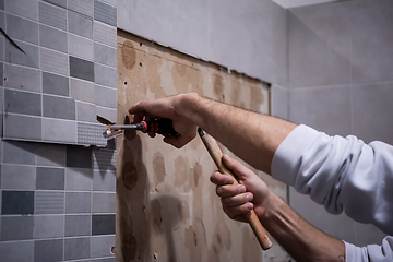 Image showing worker remove demolish old tiles in a bathroom