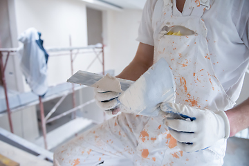 Image showing construction worker plastering on gypsum walls