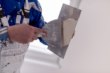 Image showing construction worker plastering on gypsum walls