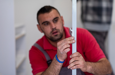 Image showing worker installing a new kitchen