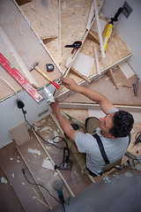 Image showing carpenter installing wooden stairs