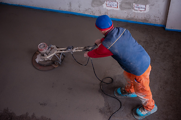 Image showing worker performing and polishing sand and cement screed floor