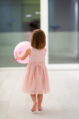 Image showing cute little girl playing with balloons