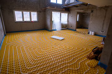 Image showing yellow underfloor heating installation with white pipes