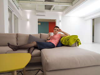 Image showing young woman enjoying free time drinking tea on sofa