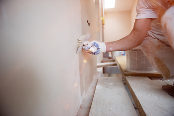 Image showing construction worker plastering on gypsum walls