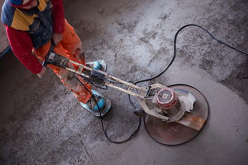 Image showing worker performing and polishing sand and cement screed floor